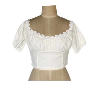 Women's woven fashion top with lace trim.